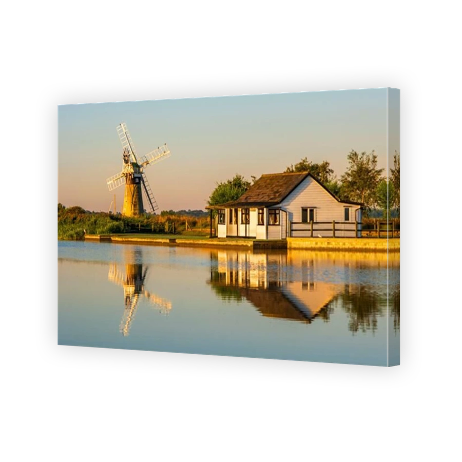 St Benet's Level Drainage Mill reflected in the river Thurne. Norfolk Broads, Norfolk, England.