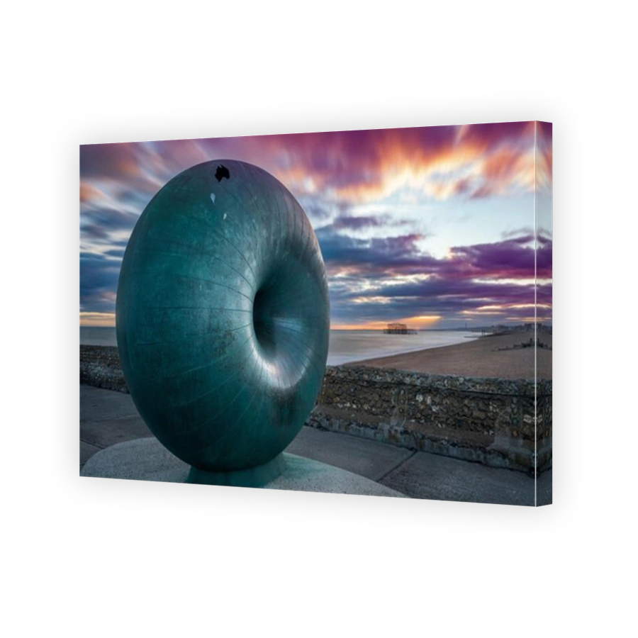 'Afloat' is a large circular doughnut shaped globe that is cast in bronze and situated on on the seafront at Brighton. The sculpture is posed as a pos