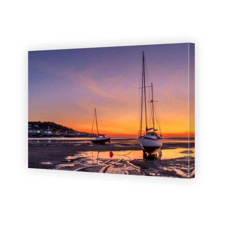 Instow beach on the last day of May. The afterglow of sunset deepens in colour before fading to blue, as across the River Torridge estuary, the lights