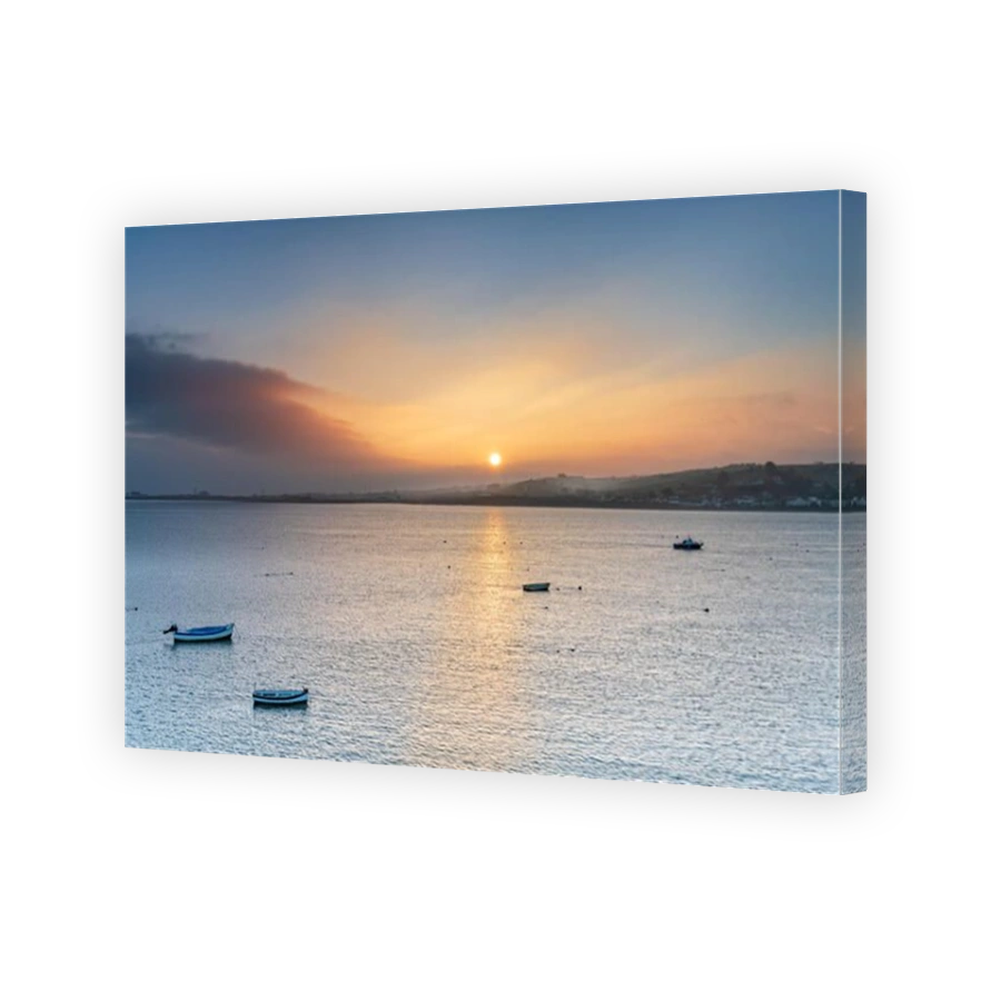 Instow, UK, 14 April, 2018. UK Weather - After days of grey skies and rain, the sun rises over the small North Devon village of Instow, as the weather looks to improve with temperatures forecast to rise in the week ahead.