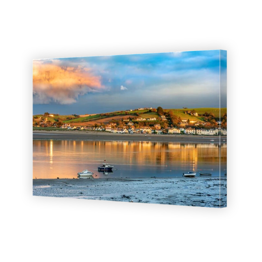 The late afternoon sunshine lights up the shoreline on the River Torridge estuary at Instow in North Devon.
