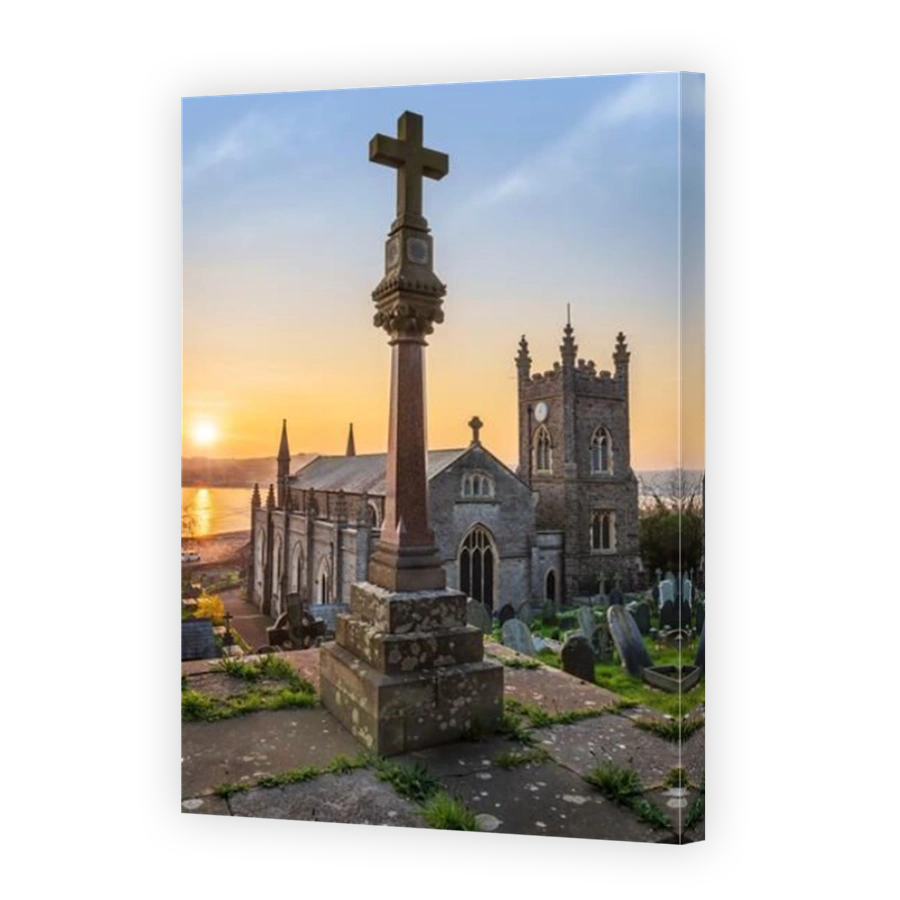 The tranquil churchyard of St Mary's is full of spring flowers as the sun rises over the River Torridge estuary in the coastal village of Appledore in
