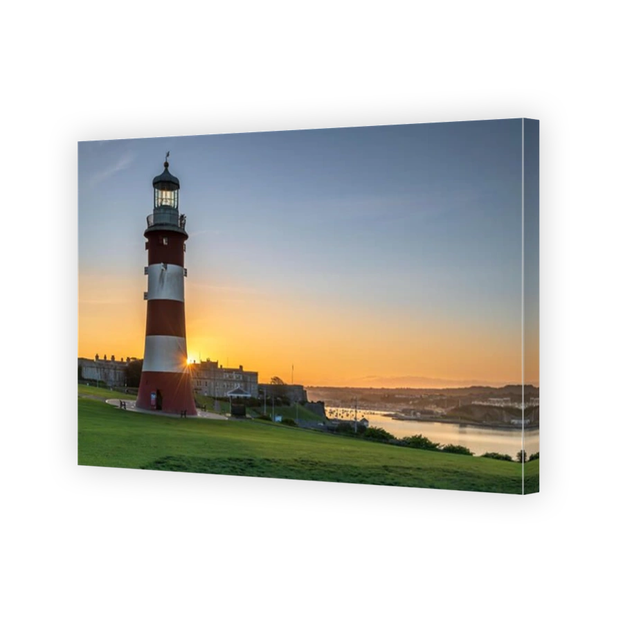 Plymouth, Devon, England. Thursday 19th September 2019. UK Weather. After another clear and chilly night, the first rays of sunshine appear behind Smeatons Tower on The Hoe, lighting up the harbour in Plymouth, Devon, South West England . Terry Mathews/Alamy Live News.