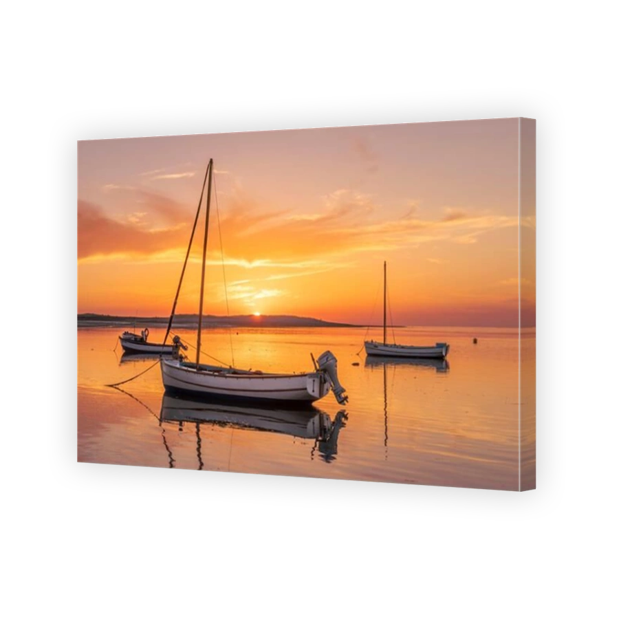 Appledore, North Devon, England. After a very hot and humid day in North Devon, the sun sets behind the headland on a tranquil River Torridge as an in