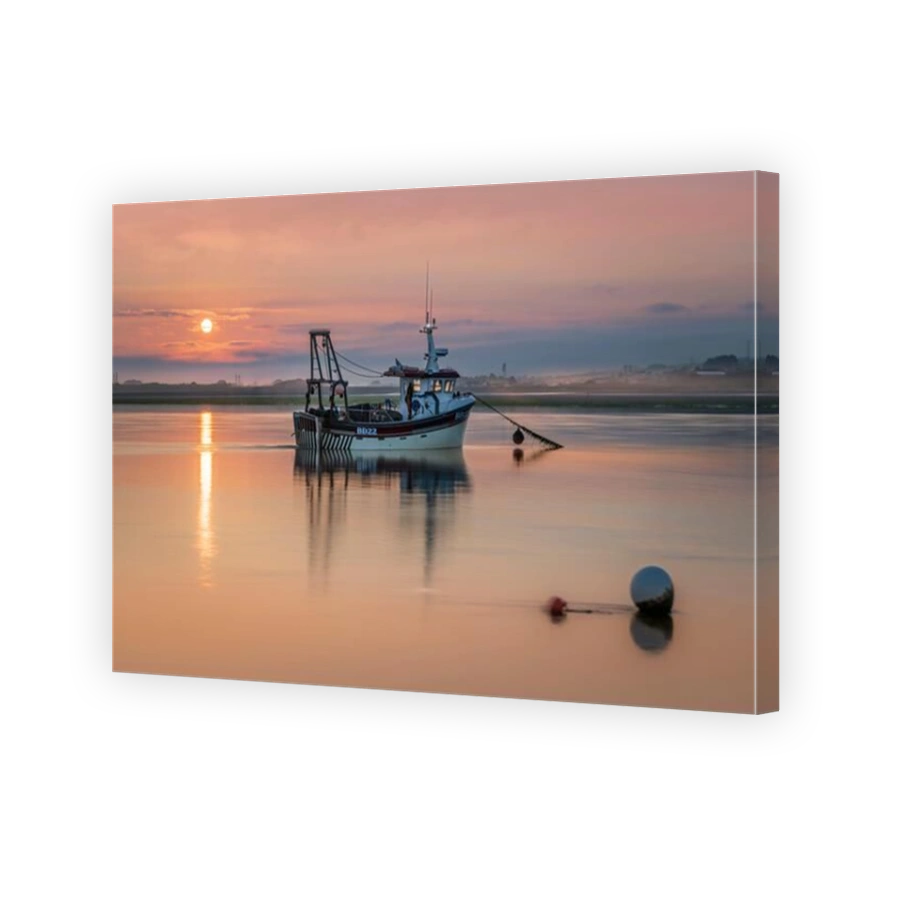 Appledore, North Devon, England.The early morning clouds give way to mist as the sun starts to rise behind the independent fishing boat 'Serene Skye',