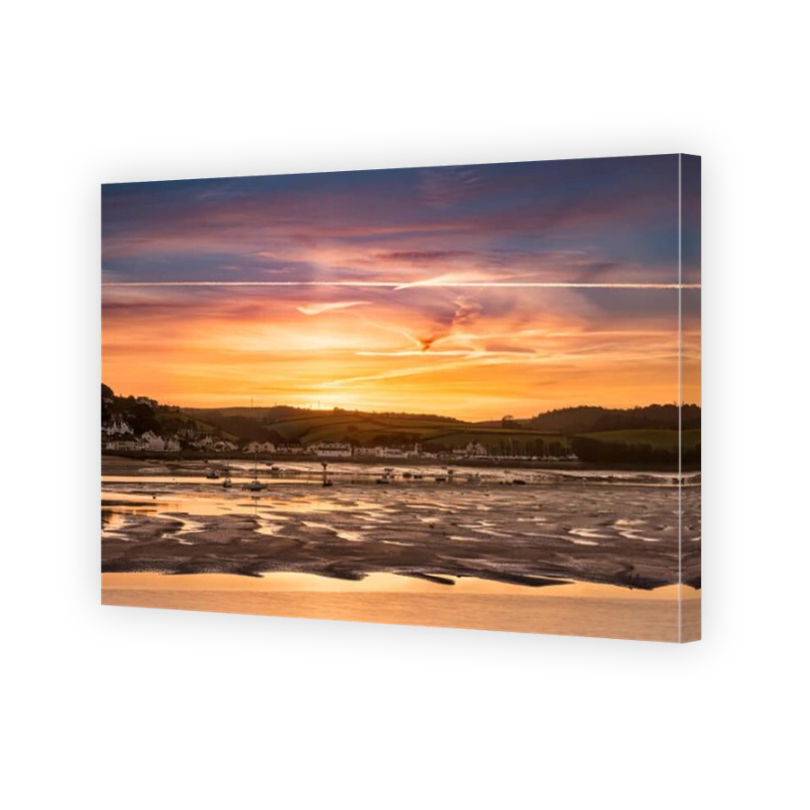 The sun rises an hour earlier, over the Devon coastal village of Instow, after the clocks go back to signal the end of British Summertime