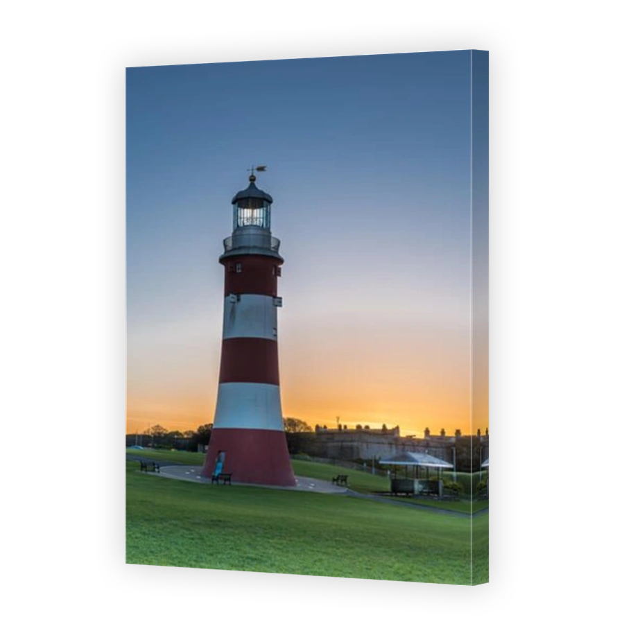 The sun rises behind the iconic Smeatons Tower on Plymouth Hoe in south Devon.