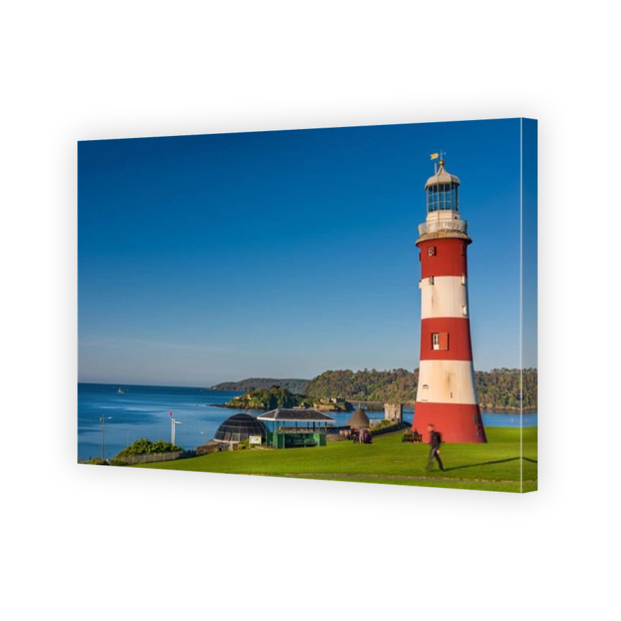 People enjoy the early morning sunshine near Smeatons Tower on Plymouth Hoe in south Devon.