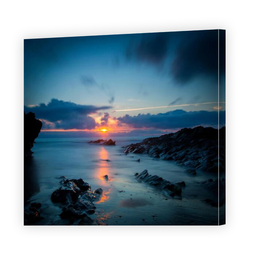Cloudy sunset over the rocks along the Cornish coast near Newquay, Cornwall, England