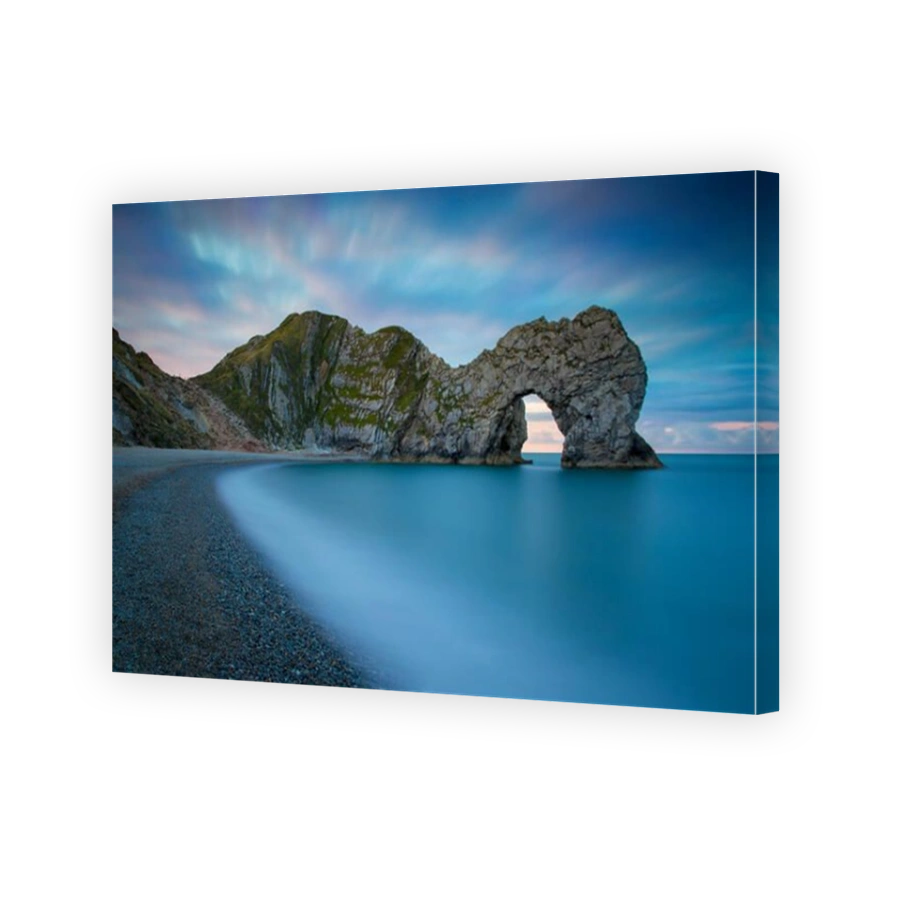 Colorful sky at dawn over Durdle Door along the Jurassic Coast, Dorset, England