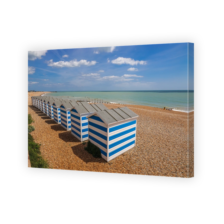 Pretty beach huts lined up on the beach of Hastings, England.