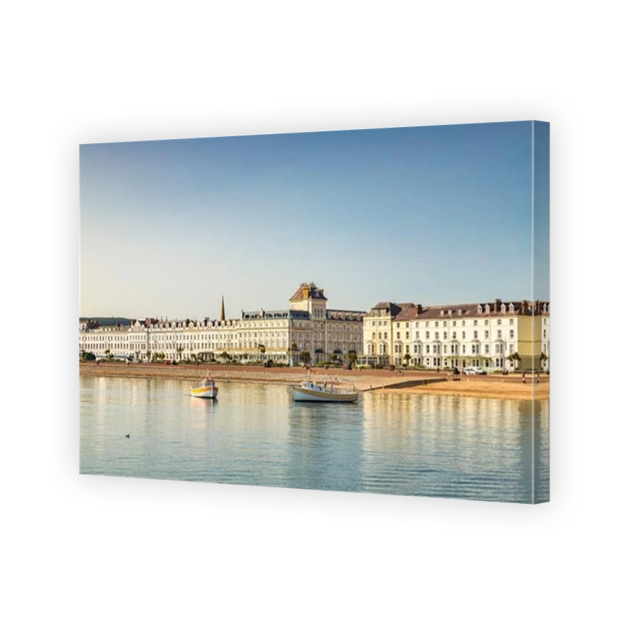 21 July 2021: Llandudno, North Wales - Pleasure cruise boats and hotels along the promenade at Llandudno on a clear summer morning.