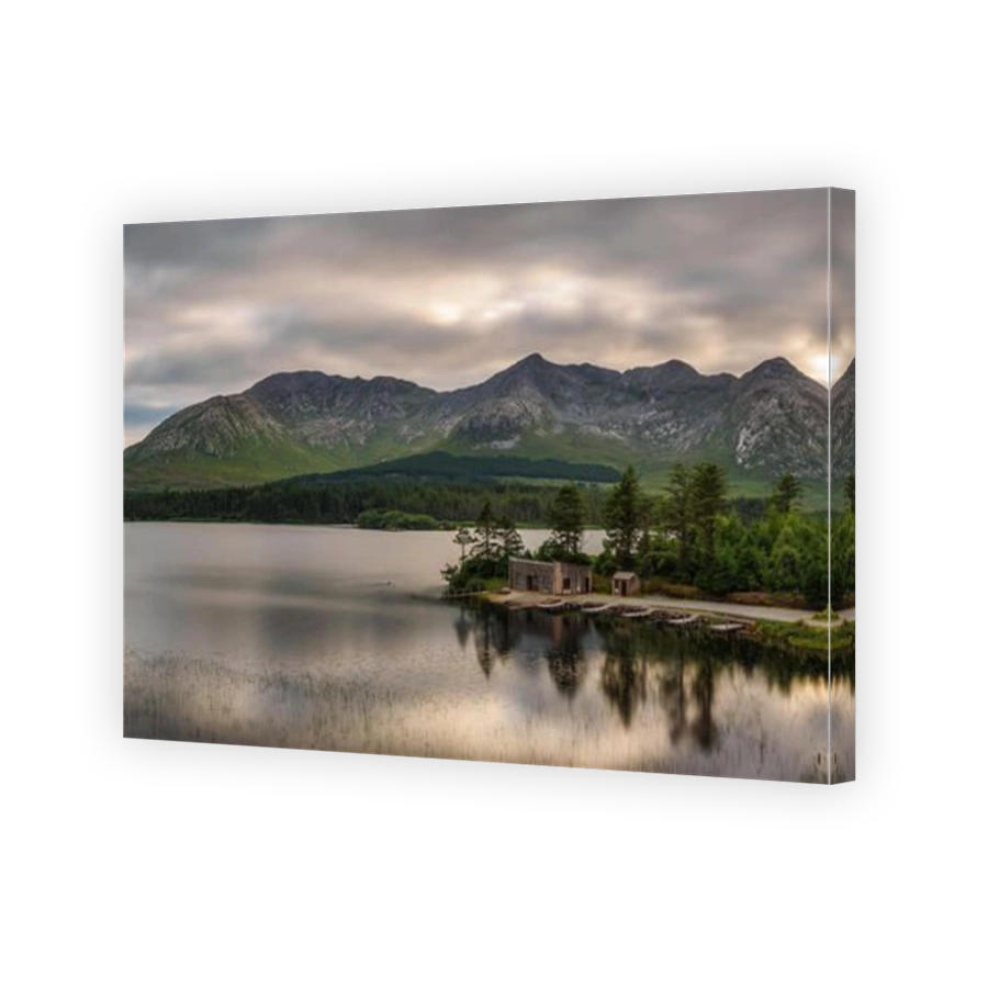 Lough Inagh in Ireland with a cabin and boats at the lake shore
