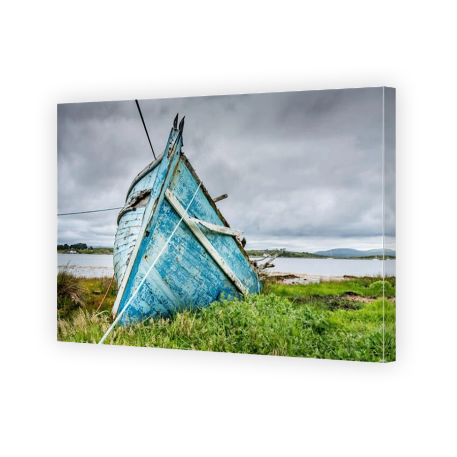 The prow of the wreck of an old blue wooden fishing boat stranded on the coast near the port of Roundstone in Connemara, Ireland