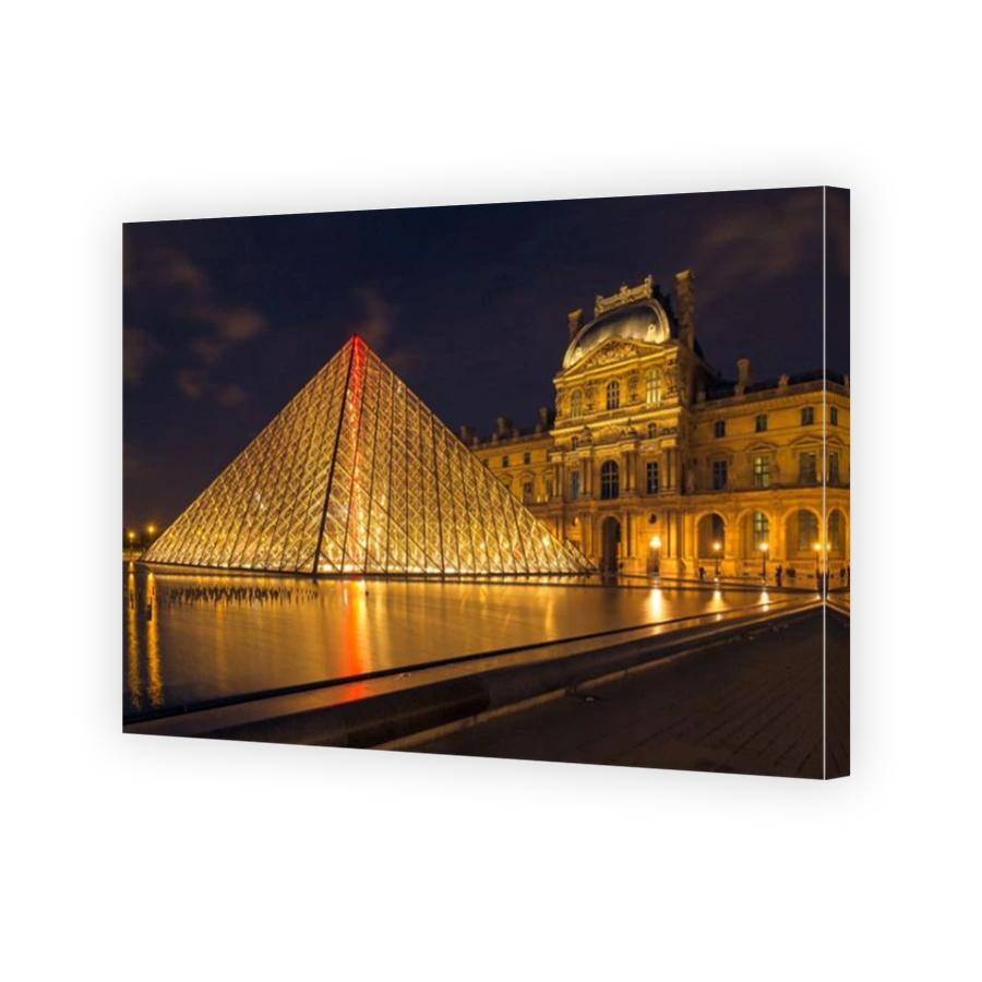 PARIS - MAY 9: Louvre Museum (Musee du Louvre) and the Pyramid in Paris, France, at night illumination on May 9, 2014. Louvre is