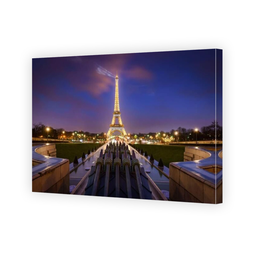 The Eiffel Tower illuminated at night with light beams. Trocadero, Champs-de-Mars, Paris