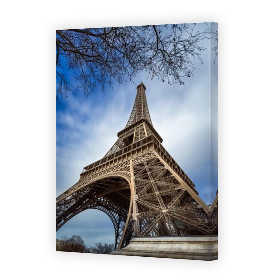 Low angle view Eiffel Tower and passing clouds, Paris, France
