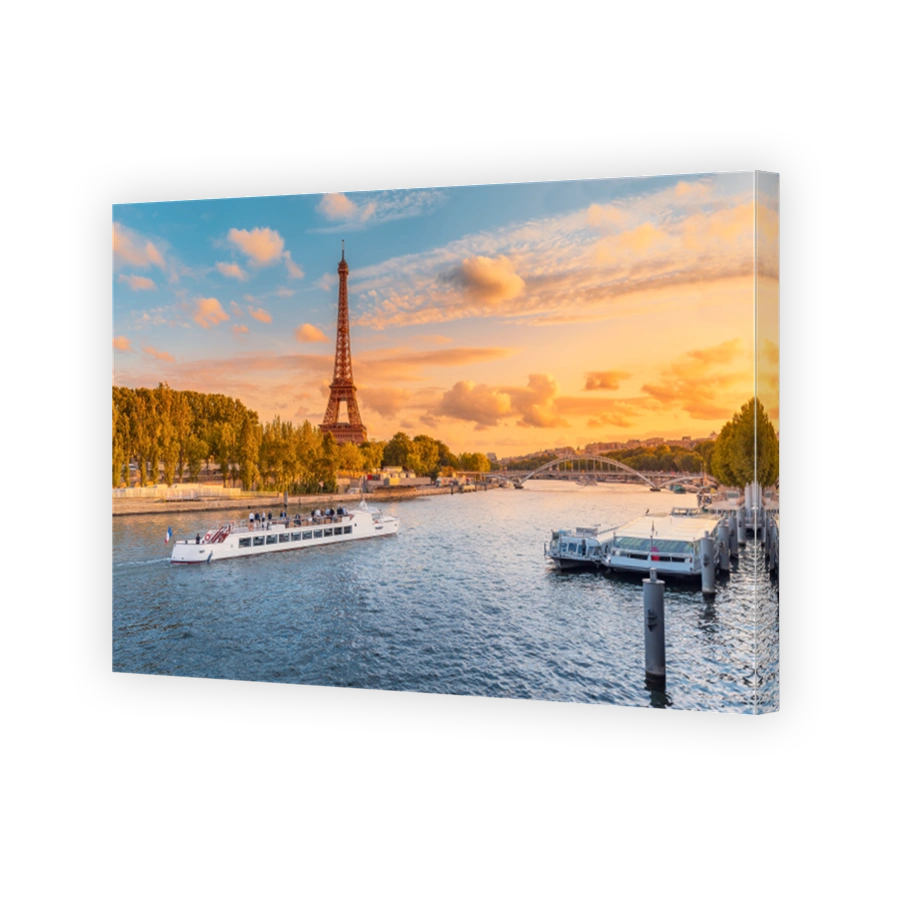 The main attraction of Paris and all of Europe is the Eiffel tower in the rays of the setting sun on the bank of Seine river with cruise tourist ships