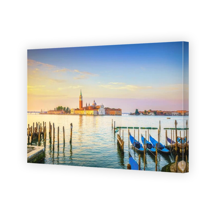 Venice lagoon at sunrise, San Giorgio Maggiore church, gondolas and poles. Italy, Europe.