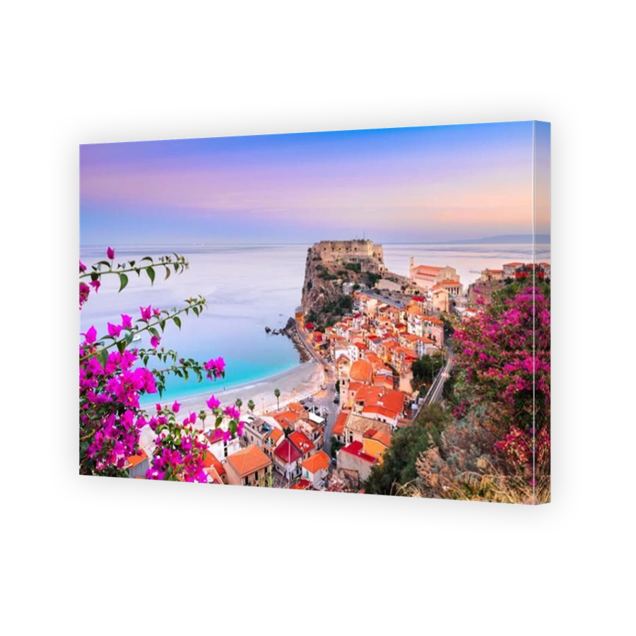 Scilla, Italy historic townscape on the coast of the Mediterranean Sea at dawn.