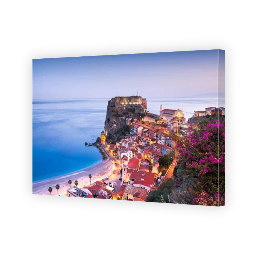 Scilla, Italy on the Mediterranean coast at twilight with seasonal flowers.