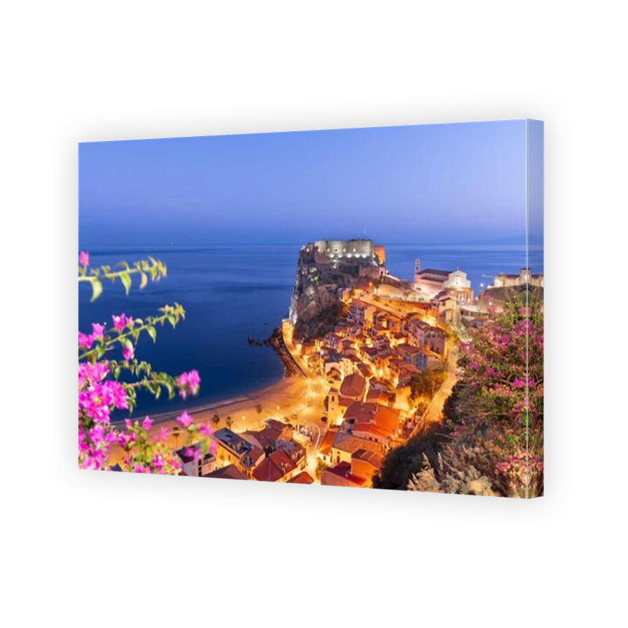 Scilla, Italy on the Mediterranean coast at twilight with seasonal flowers.