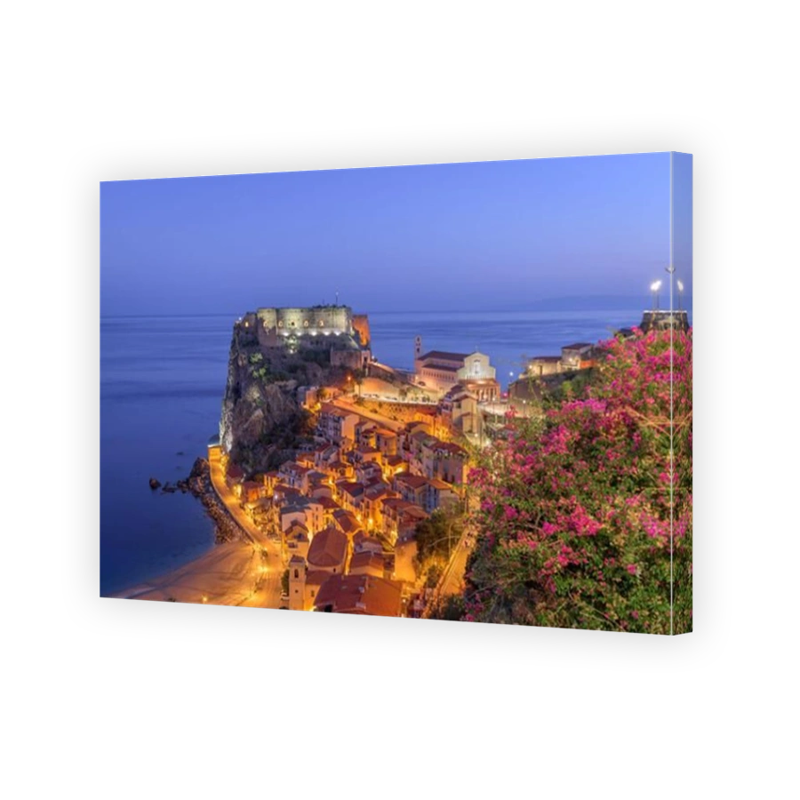 Scilla, Italy on the Mediterranean coast at twilight with seasonal flowers.