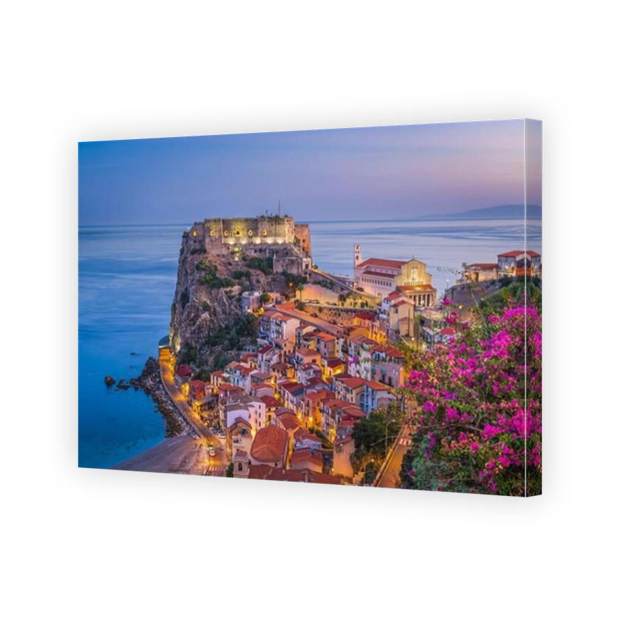 Scilla, Italy on the Mediterranean coast at twilight with seasonal flowers.