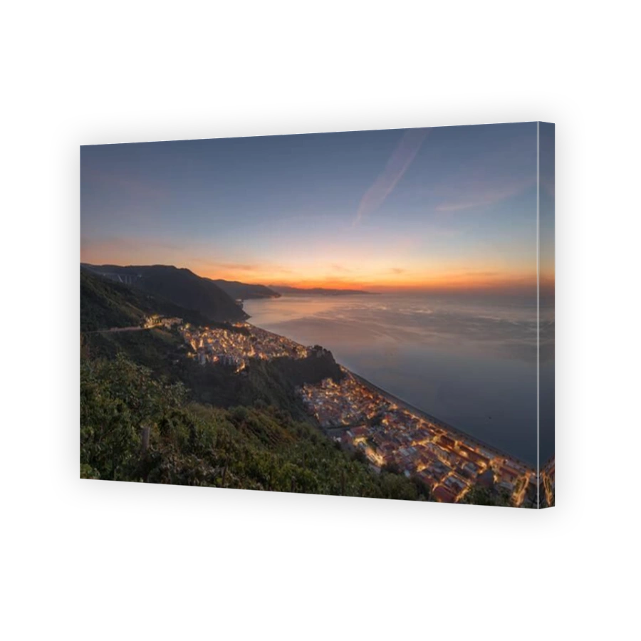 Bagnara Calabra, Italy cityscape overlooking the Tyrrhenian Sea at dusk.