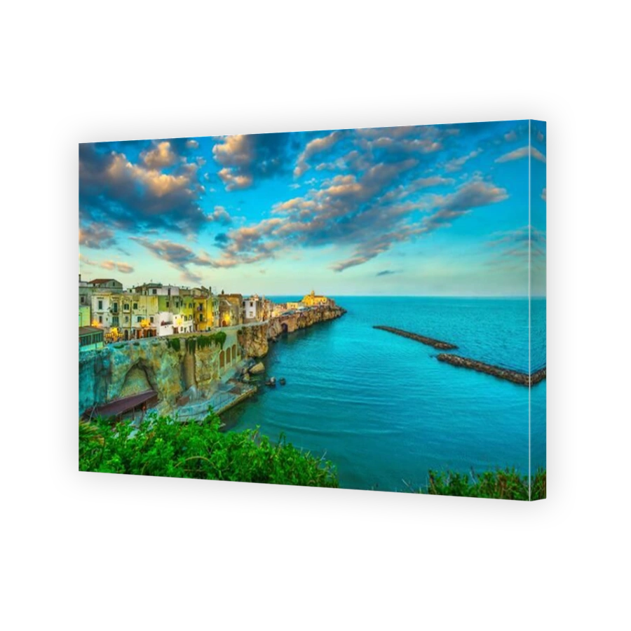 Vieste town on the rocks at sunset, Gargano peninsula, Apulia, southern Italy, Europe.
