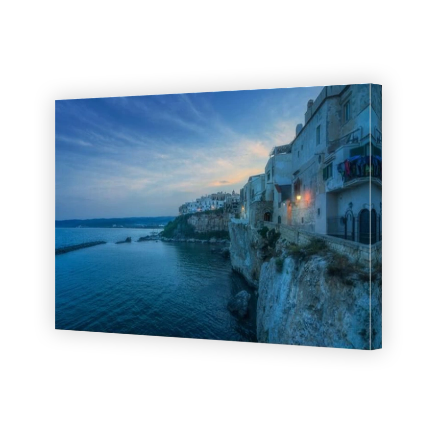 Vieste town on the cliffs at twilight. Gargano peninsula, Apulia or Puglia region, Italy, Europe.