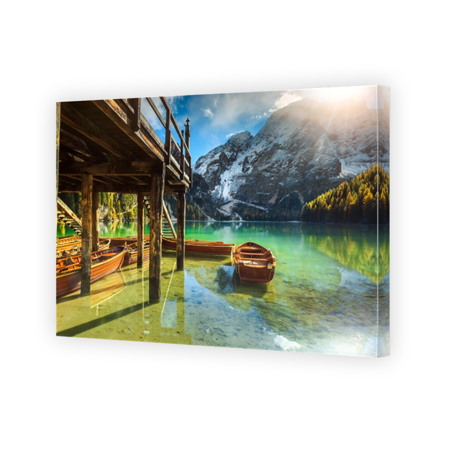 Wooden boathouse and boats on the alpine lake, Dolomites, Italy