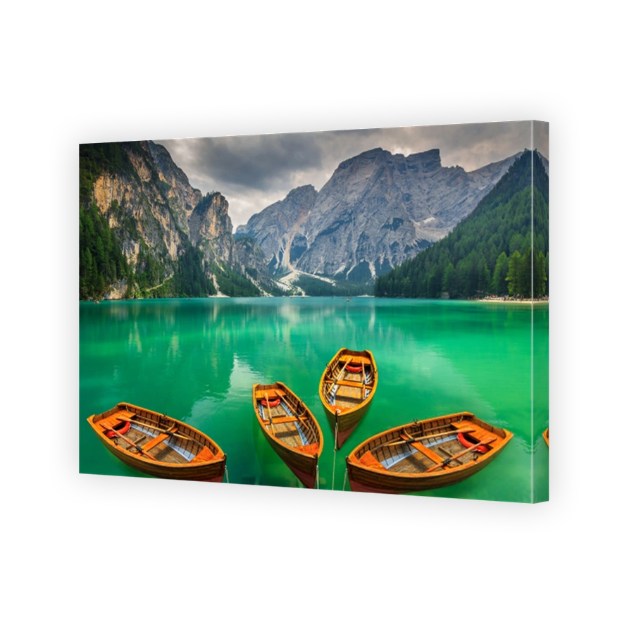 Beautiful mountain lake with wooden boats in the Dolomites,Italy
