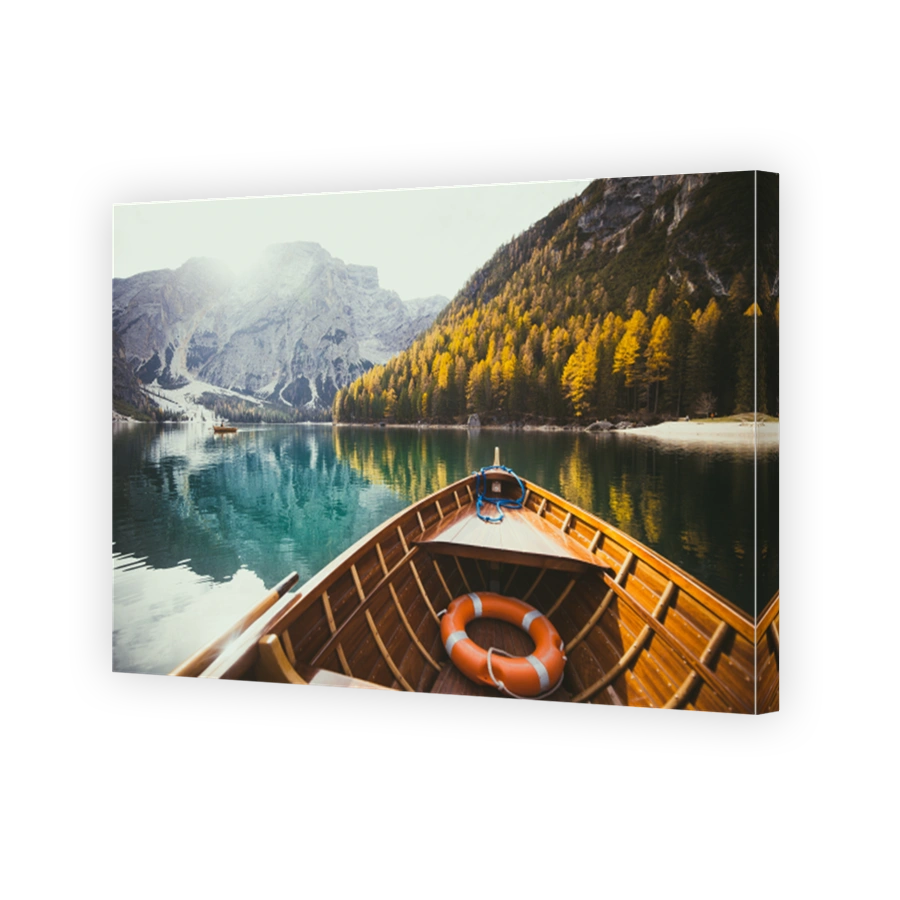 Traditional rowing boat on a lake in the Alps in fall