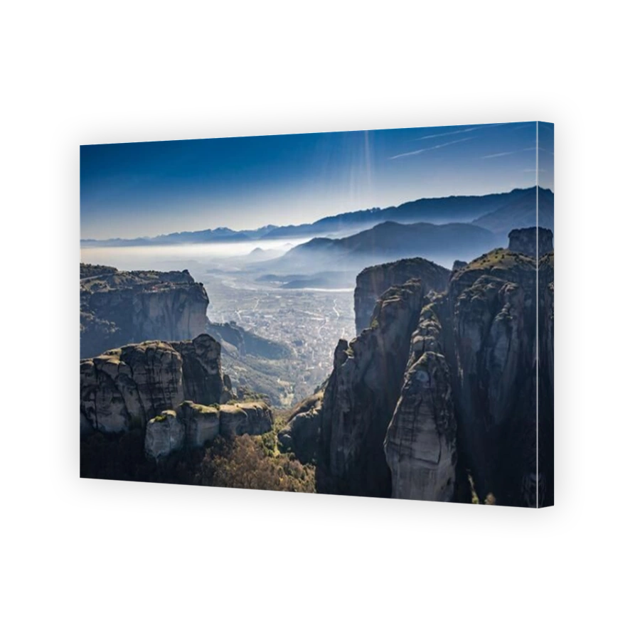 Aerial view of Unesco monument Meteora, the mountains, the landmark of Greek, sunny weather, fog, haze over a valley