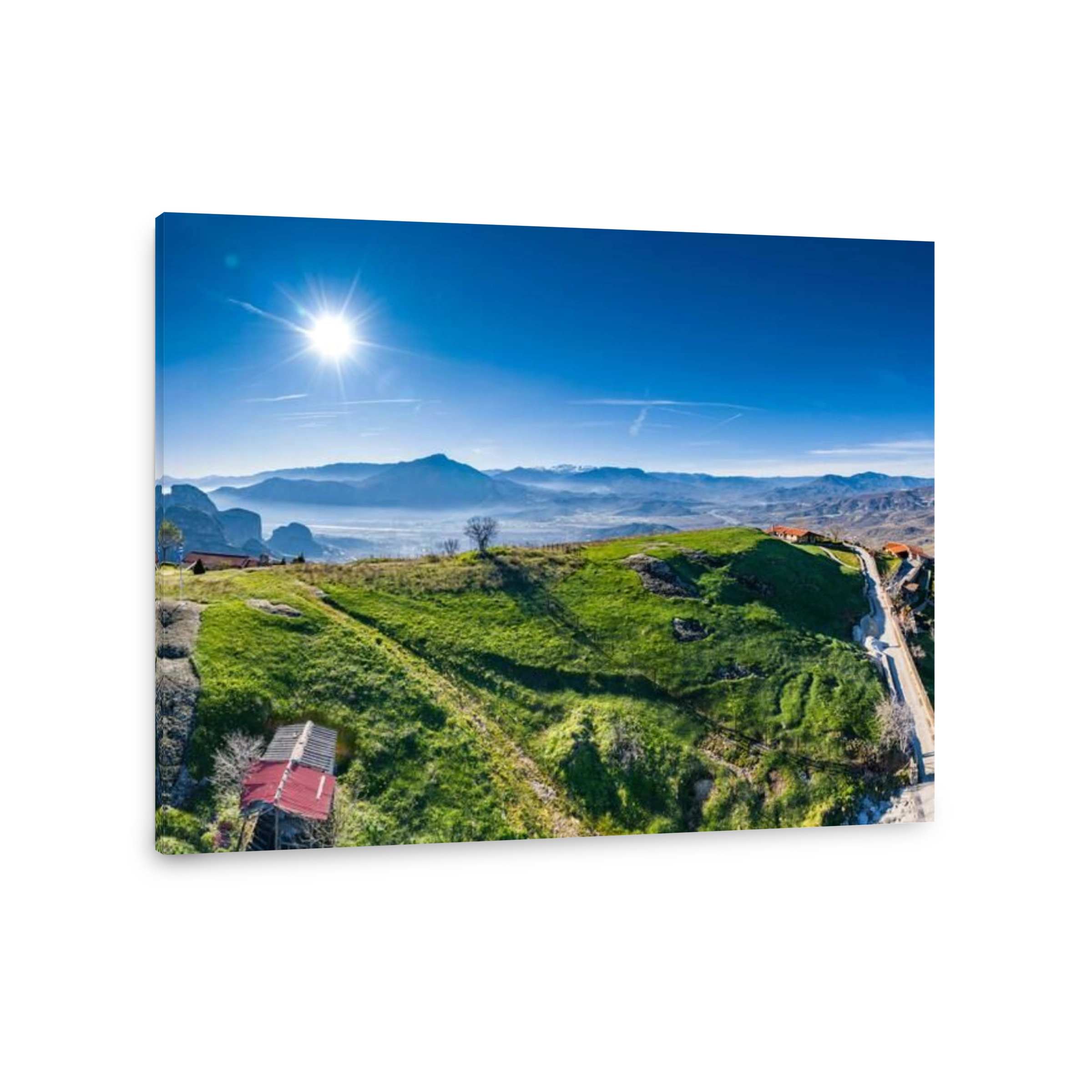 Aerial view of monastery of landmark canyon of Meteora and breathtaking picturesque valley at sunset, shadows, twisted road, green lawn
