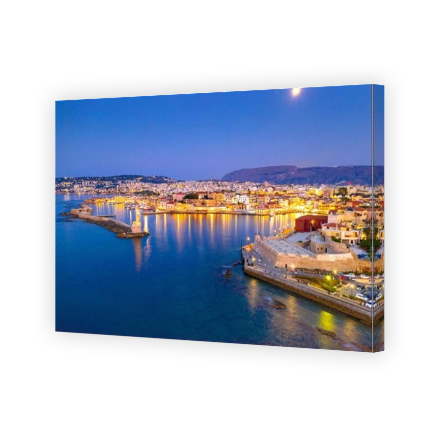 Panorama of the beautiful old harbor of Chania with the amazing lighthouse, mosque, venetian shipyards, at sunset, Crete, Greece.