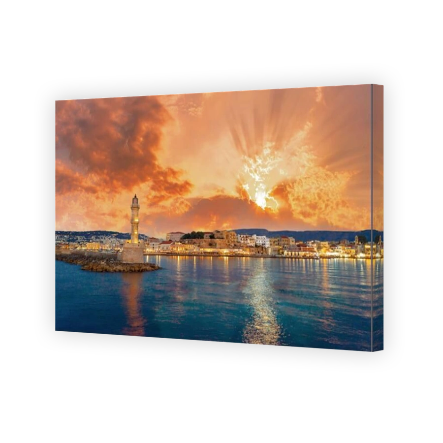 Panorama of the beautiful old harbor of Chania with the amazing lighthouse, mosque, venetian shipyards, at sunset, Crete, Greece.