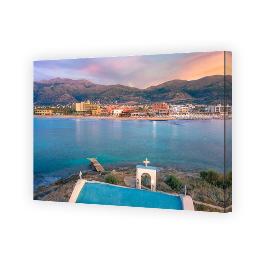 An old white church in a small island at sunset in Malia, Crete, Greece.