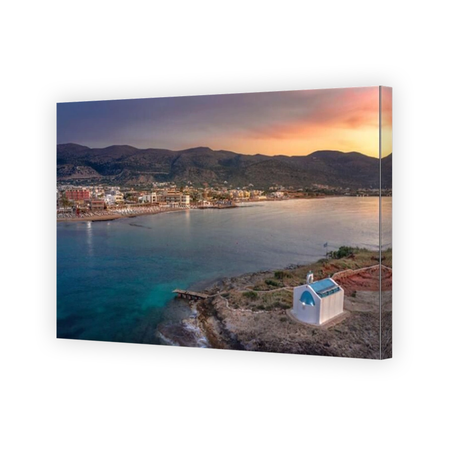 An old white church in a small island at sunset in Malia, Crete, Greece.