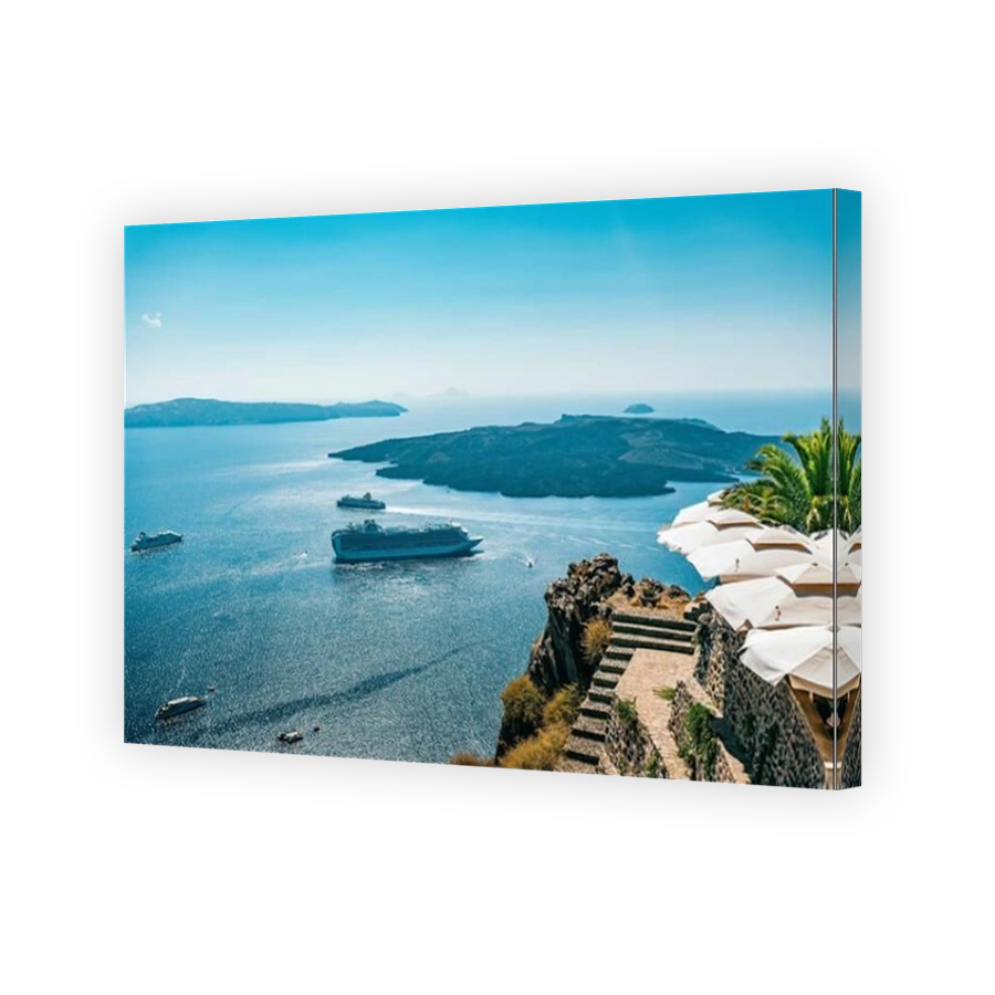 An aerial view of luxury cruise ships sailing through the sea at Oia on Santorini, Greece
