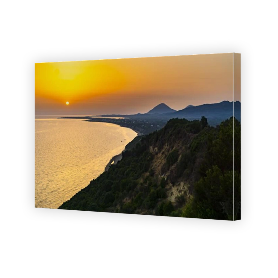 Aerial view of the calm Ionian sea and the Corfu Island gleaming under the sunset on the coast