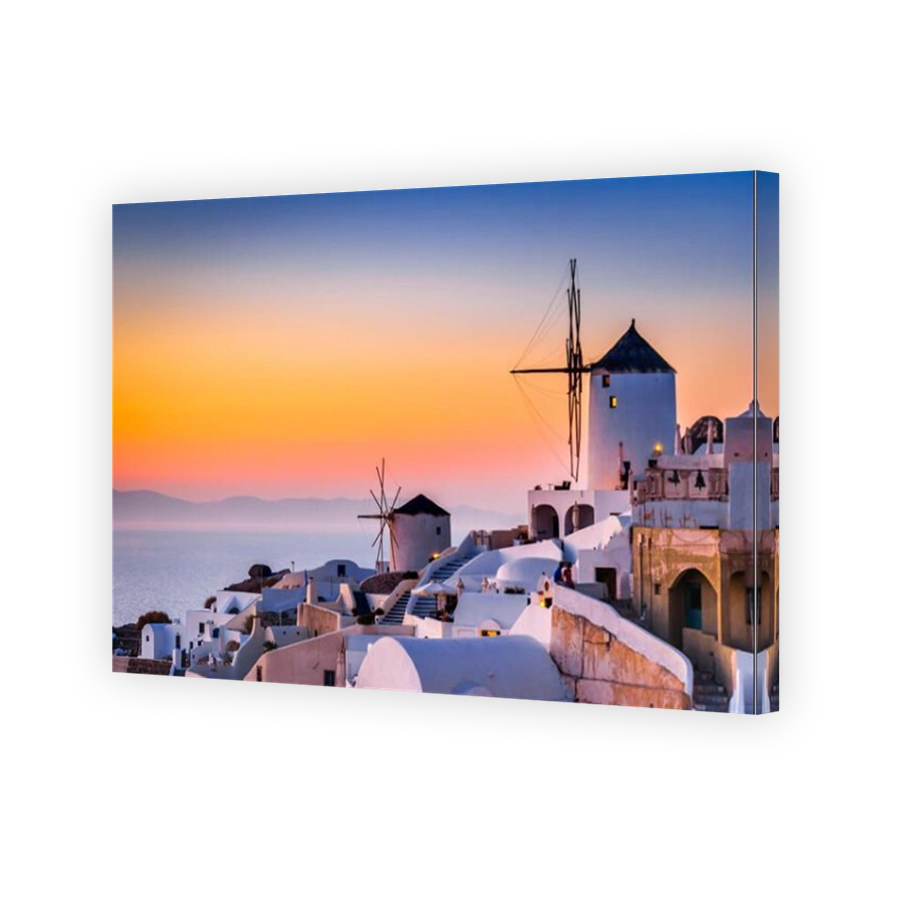 Santorini, Greece. Famous attraction of Oia village at sunset with windmill in Greek Islands, Aegean Sea.