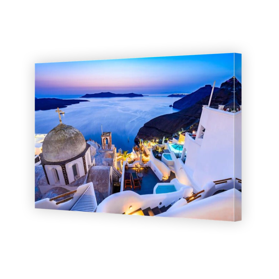 Fira, Santorini - Greek Islands landmark with white village, cobbled paths, greek orthodox blue church and sunset over caldera. Cyclades, Greece.