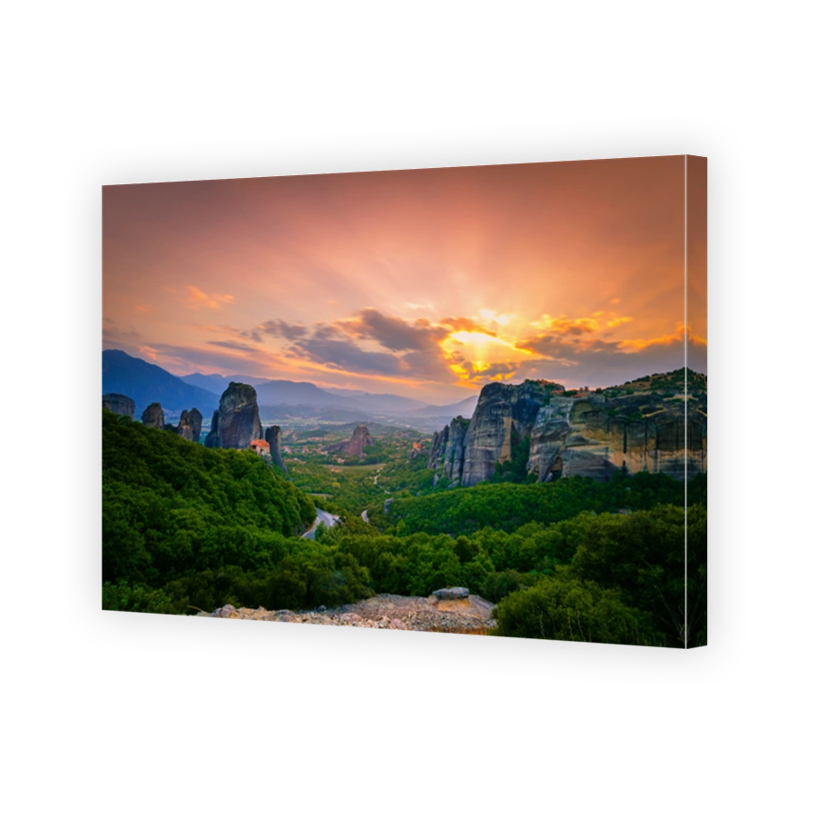 Breathtaking view of Meteora Roussanou Monastery at sunset, Greece. Geological formations of big rocks with Monasteries  on top of them.
