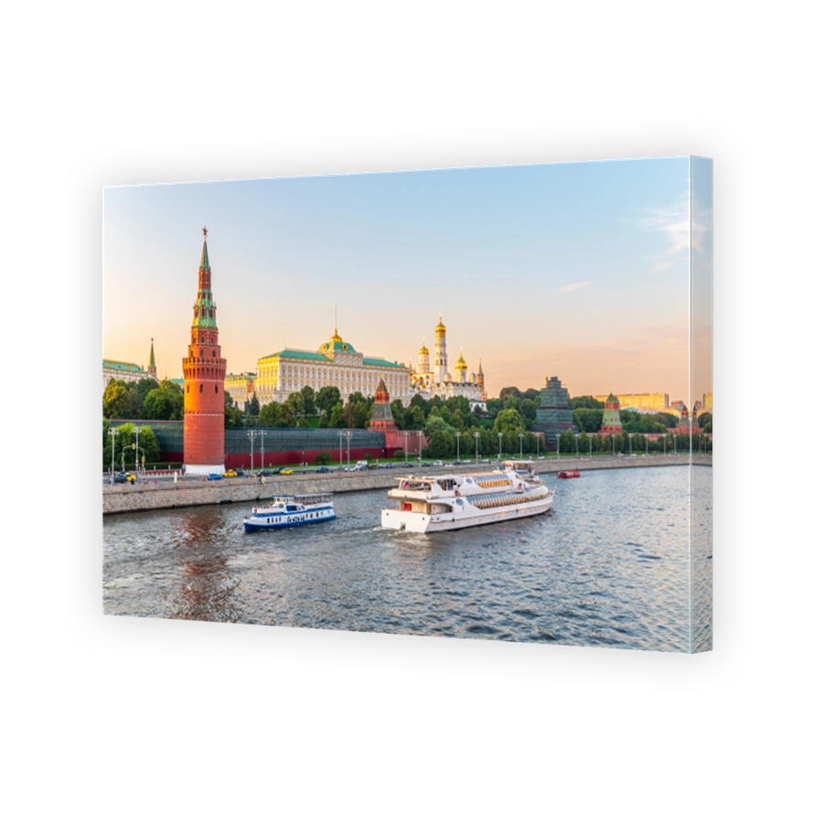 View of Kremlin with Vodovzvodnaya tower, Grand Kremlin Palace from repaired Bolshoy Kamenny Bridge in Moscow city on sunny summer day. Cruise ship sails on the Moscow river