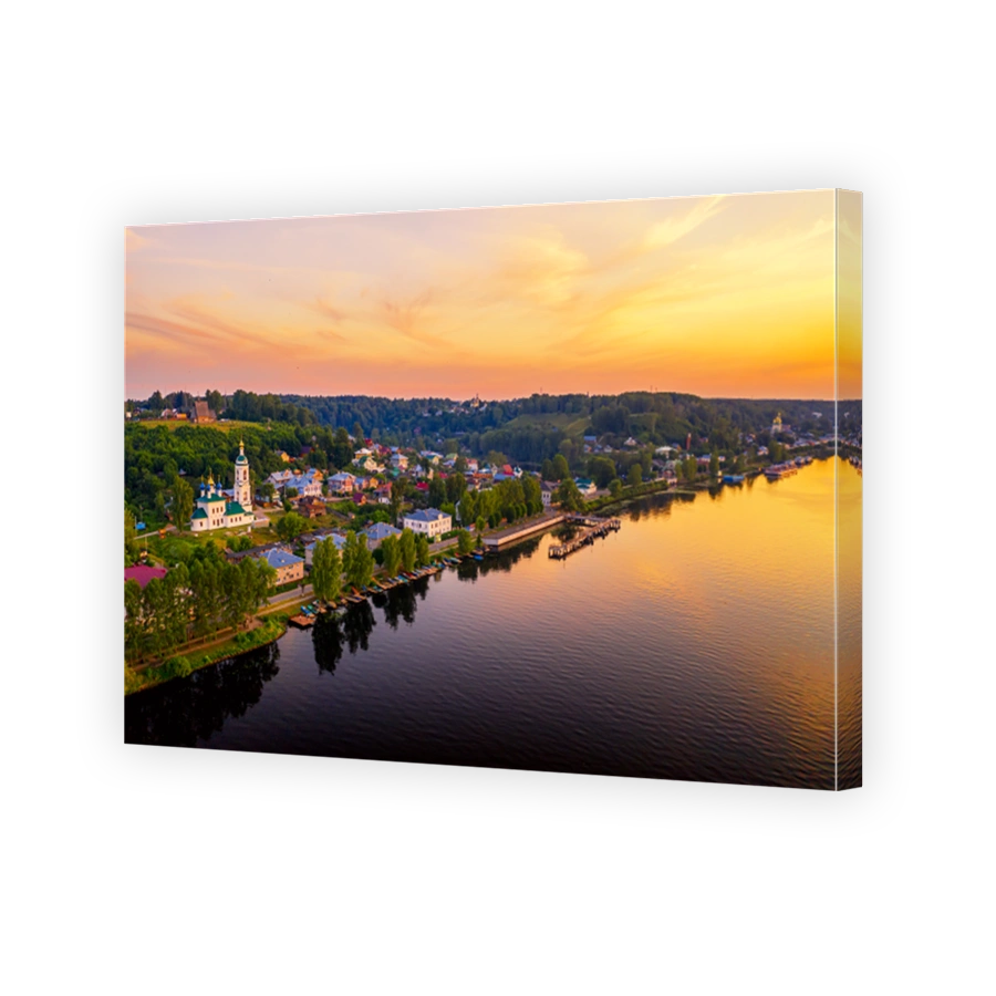 Aerial drone view of ancient russian town Ples on the Volga river with colorful sunset