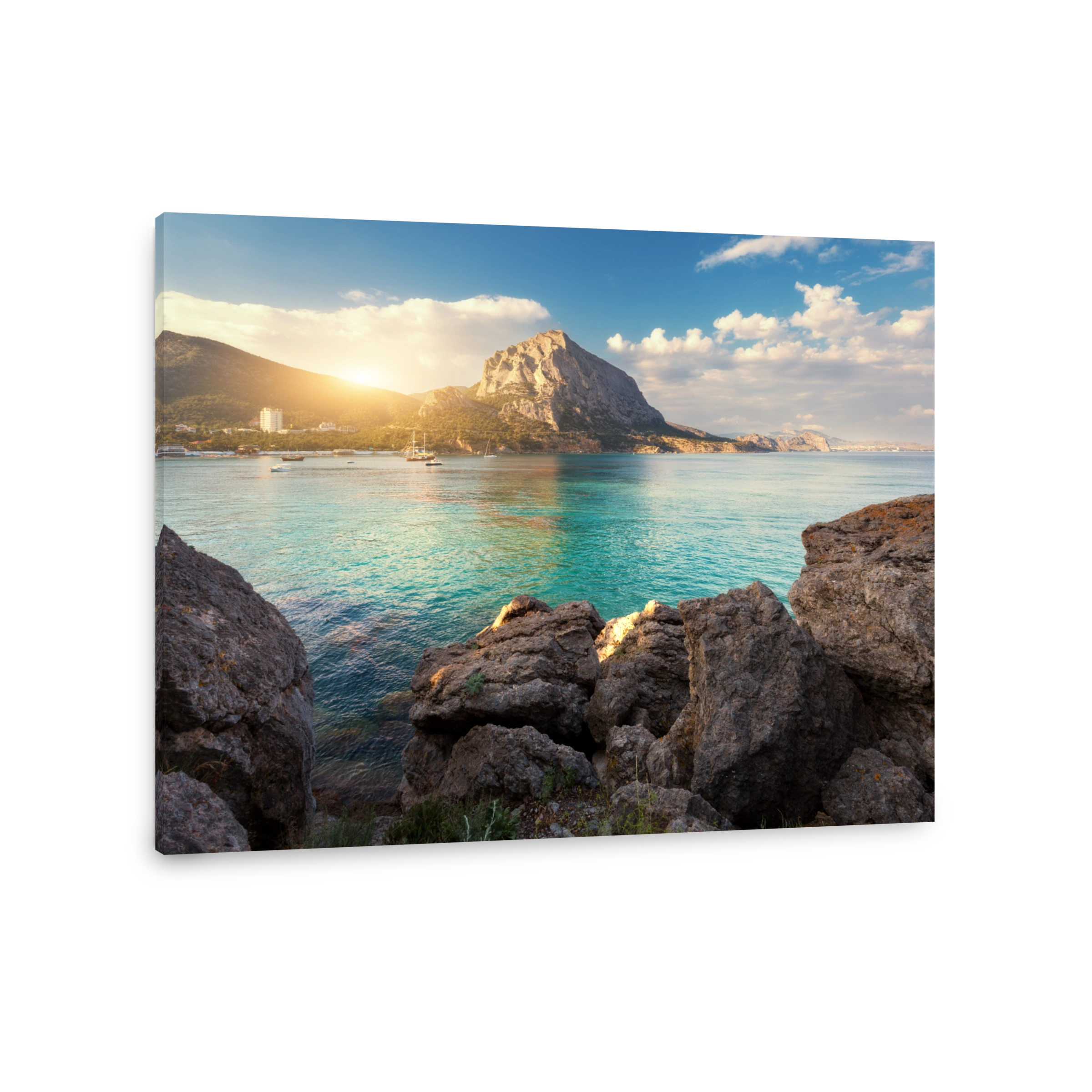 Summer seascape at sunset. Stones and rocks by the sea against mountains and blue sky with clouds and sunlight. Travel and nature background. Colorful landscape. Turquoise sea. Vacations in Crimea