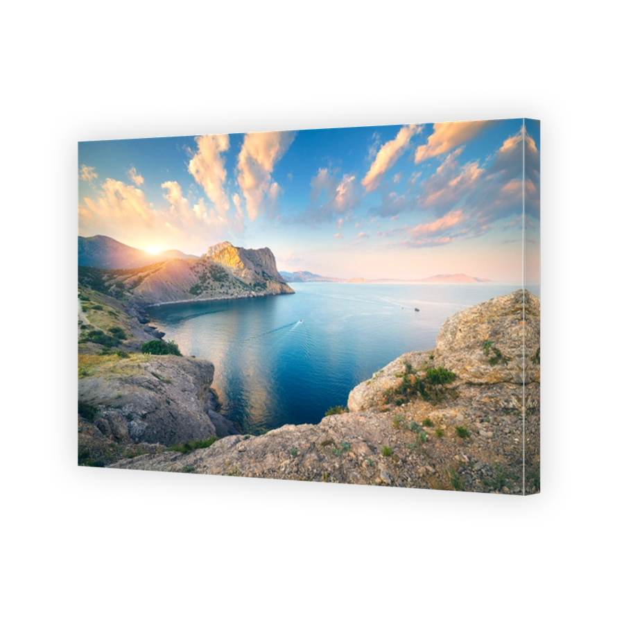 Amazing mountain landscape at sunset. Beautiful scene with mountains, blue sea, high rocks, beach, forest and colorful blue sky with clouds in summer. Travel in Europe. Seascape. Nature background