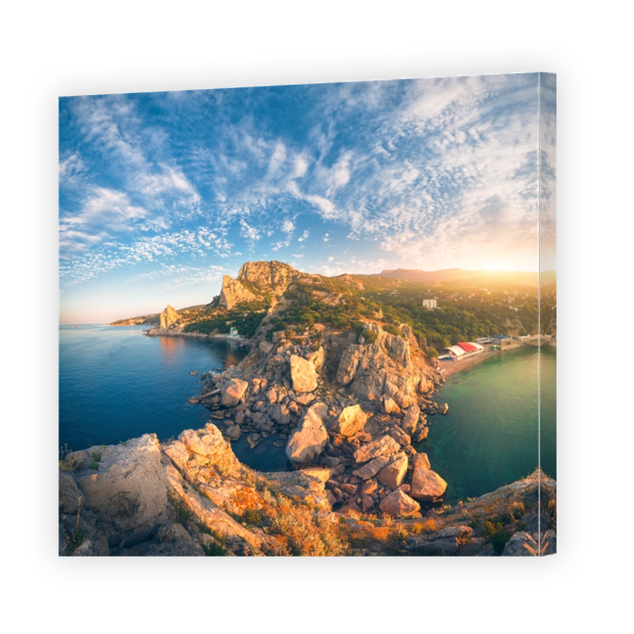 Amazing mountain landscape at sunrise. Beautiful view from the mountain peak on the blue sea, high rocks, beach, forest and colorful blue sky with clouds in summer. Travel in Europe. Seascape